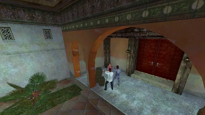 Cate Archer and two guards in a Moorish arcade with red doors.
